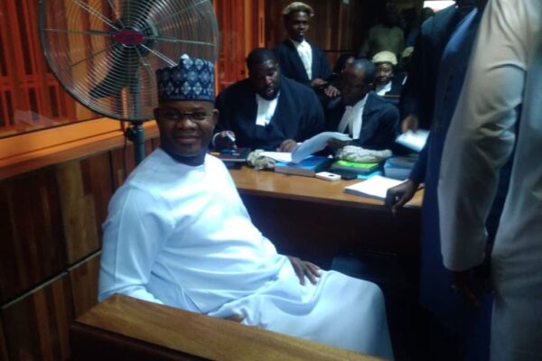 A man wearing white native.